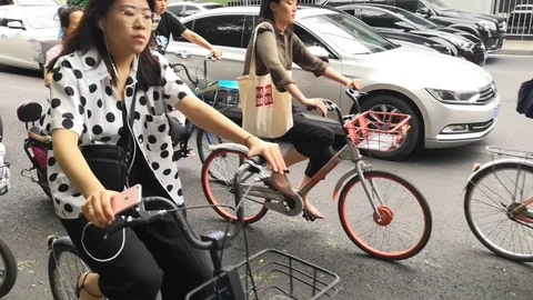 People cycle on the road after work Stock Footage 111680905
