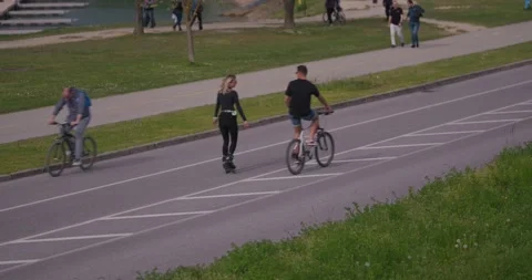 People cycling and rollerblading on road near Jarun 스톡 동영상 332622053
