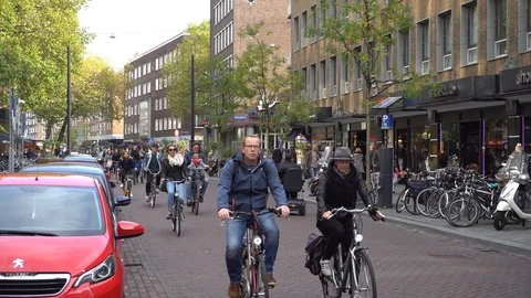 People cycling on a street in Rotterdam during winter sunny day Stock Footage