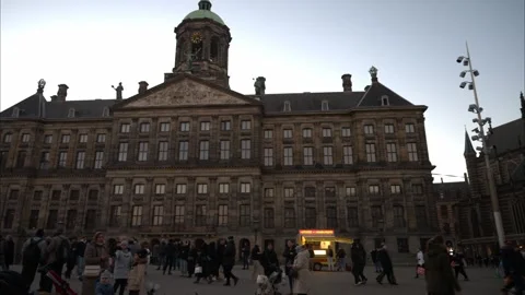 People on Dam square in city centre. Royal Palace. Historical buildings. Stock Footage 259030626
