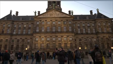 People on Dam square in city centre. Royal Palace. Historical buildings. Stock Footage 259030628