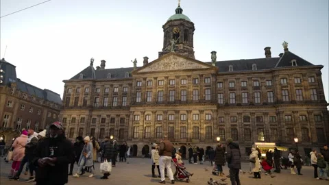 People on Dam square in city centre. Royal Palace. Historical buildings. Stock Footage 259030693