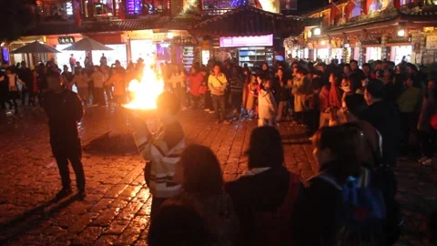 People dance around a fire in the old town of Lijiang Stock Footage 336749942