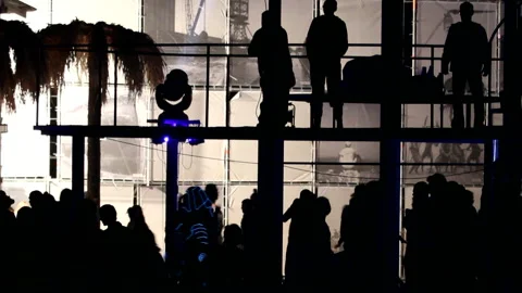 People dance on the balcony above the crowd. fast moving. Stock Footage 120424817