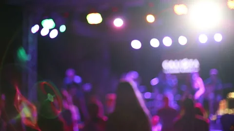 People dance to the band's performance. Defocused shot. Stock Footage 43313556