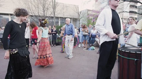 People dancing and drummers during Drum circle - Friday evenings Asheville, NC Stock Footage 103433824