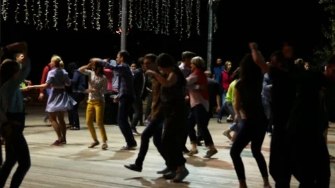 People dancing and having fun under the open sky in a summer park Stock Footage 107689898