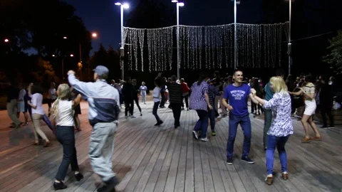 People dancing and having fun under the open sky in a summer park Stock Footage 107689919