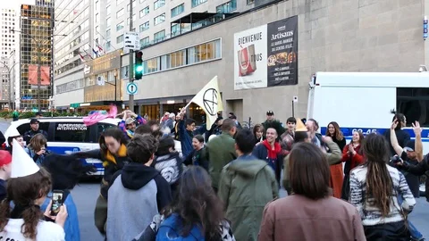 People dancing and pushing each other in front of police officers Stock Footage 120040007