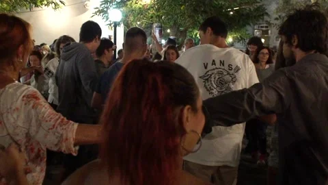 People dancing in circles holding hands in an Ikarian festival Stock Footage 144483154