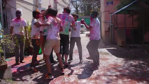 People dancing with colors all over their body on Holi during the day Stock Footage 77448037