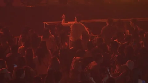 People dancing in Concert with Orange lighting slowmotion Stock-Footage 156123799