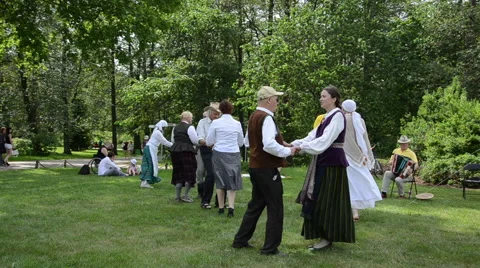 People dancing folk dances in pairs in park folk event Stock Footage 44336343