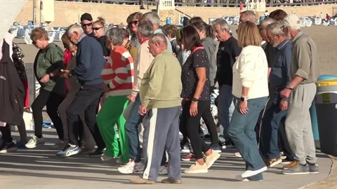People dancing as a group together in benidorm city in spain Stock Footage 315035696