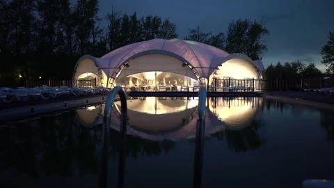 People dancing inside a tent with nightlights. Glamping at night. Slow motion Stock Footage 199627136