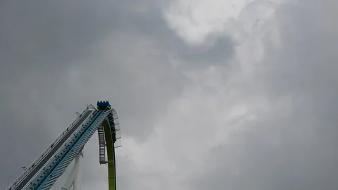 People Descend on a Rollercoaster Under Cloudy Skies Video stock 332381172