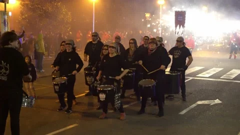 People in devil costumes play drums at night during a fiery procession Stock Footage 150320472
