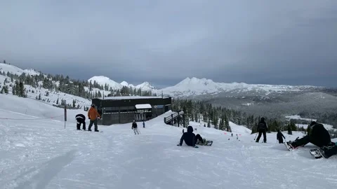 People of different age getting ready to go ski and snowboard down the mountain Stock Footage 220240655