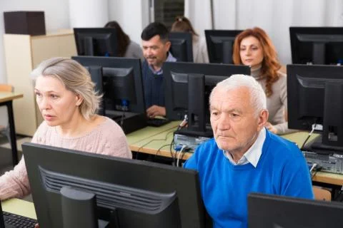 People of different ages learning to use computers Stock Photos