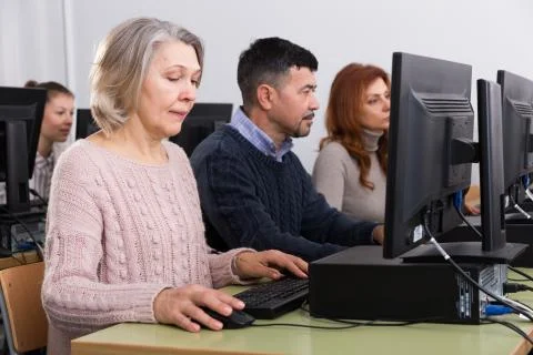 People of different ages learning to use computers Fotos de archivo