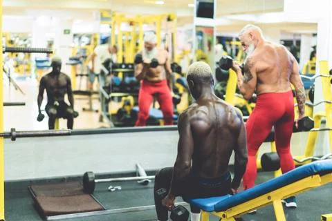 People from different generation and ethnicities doing workout sessions insid Stock Photos