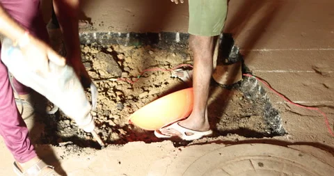 People digging pit on tar road Night Stock Footage 324525187