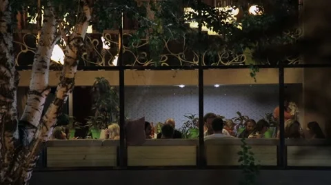 People dine at night. Looking through the window Stock Footage 41424752