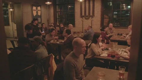 People Dining and Socializing at Night in a Busy Beijing Restaurant Setting Stock Footage 345755346