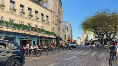 People dining at Le Saint Jean brasserie on Rue des Abbesses in Montmartre Stock Footage 337784026