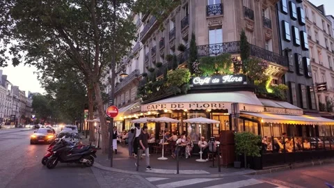 People dining outside Café de Flore along Paris boulevard at dusk Stock-Footage 336707151