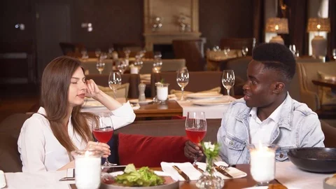 People dining at restaurant, lifestyle in resort, man and woman on honeymoon Stock Footage