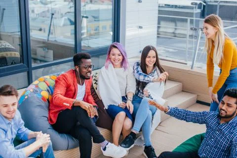 People discussing working process while sitting at the office lounge outdoor 스톡 사진