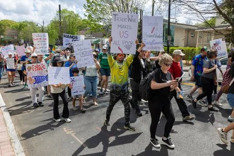 People display signs while marching in nationwide Hands Off protest Foto stock