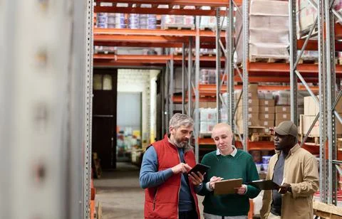 People distributing their work in warehouse Fotos Stock