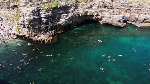 People diving and swimming into the blue Mediterranean sea Stock Footage