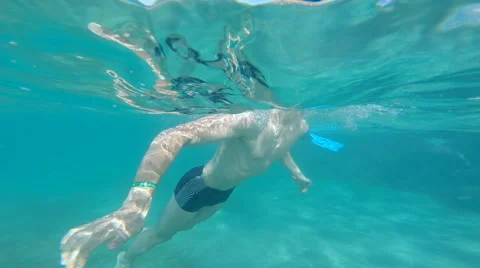People diving under the warm cyan water. Stock Footage 62532824