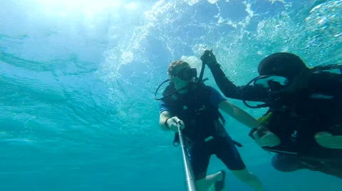 People diving under the warm cyan water. Stock Footage 62534470
