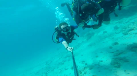 People diving under the warm cyan water. Stock Footage 62534513