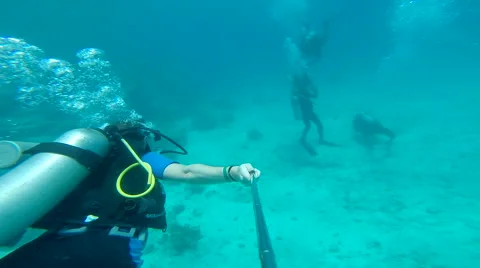 People diving under the warm cyan water. Stock Footage 62534518
