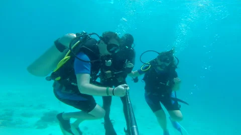 People diving under the warm cyan water. Stock Footage 62534544