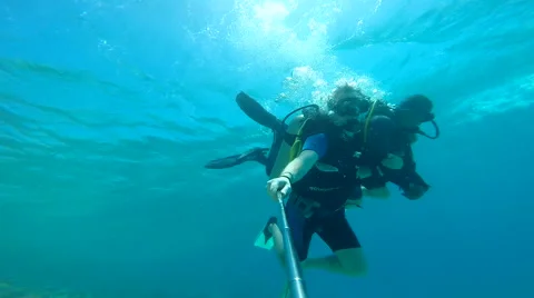 People diving under the warm cyan water. Stock Footage 62534554