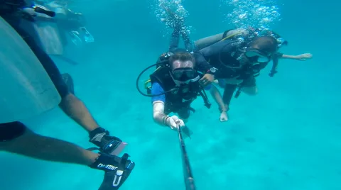 People diving under the warm cyan water. Stock Footage 62534577