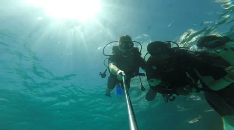 People diving under the warm cyan water. Stock Footage 62534642