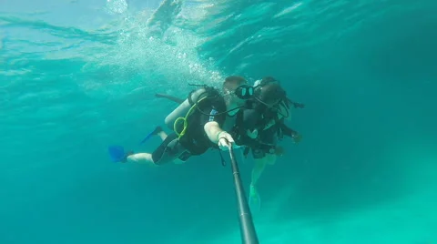 People diving under the warm cyan water. Stock Footage 62534698