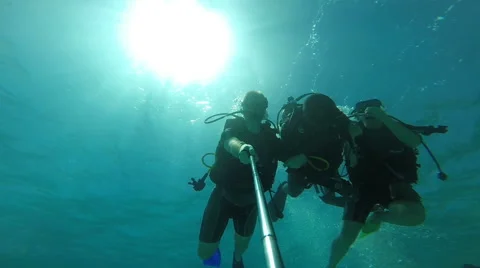 People diving under the warm cyan water. Stock Footage 62534810