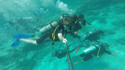 People diving under the warm cyan water. Stock Footage 62534813