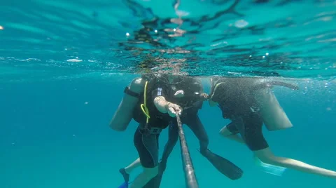 People diving under the warm cyan water. Stock Footage 62534827