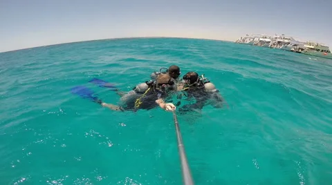 People diving under the warm cyan water. Stock Footage 62534835