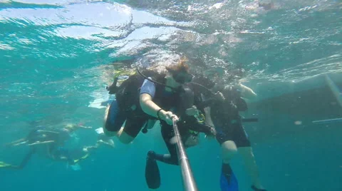 People diving under the warm cyan water. Stock Footage 62534843
