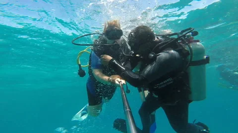 People diving under the warm cyan water. Stock Footage 62534858